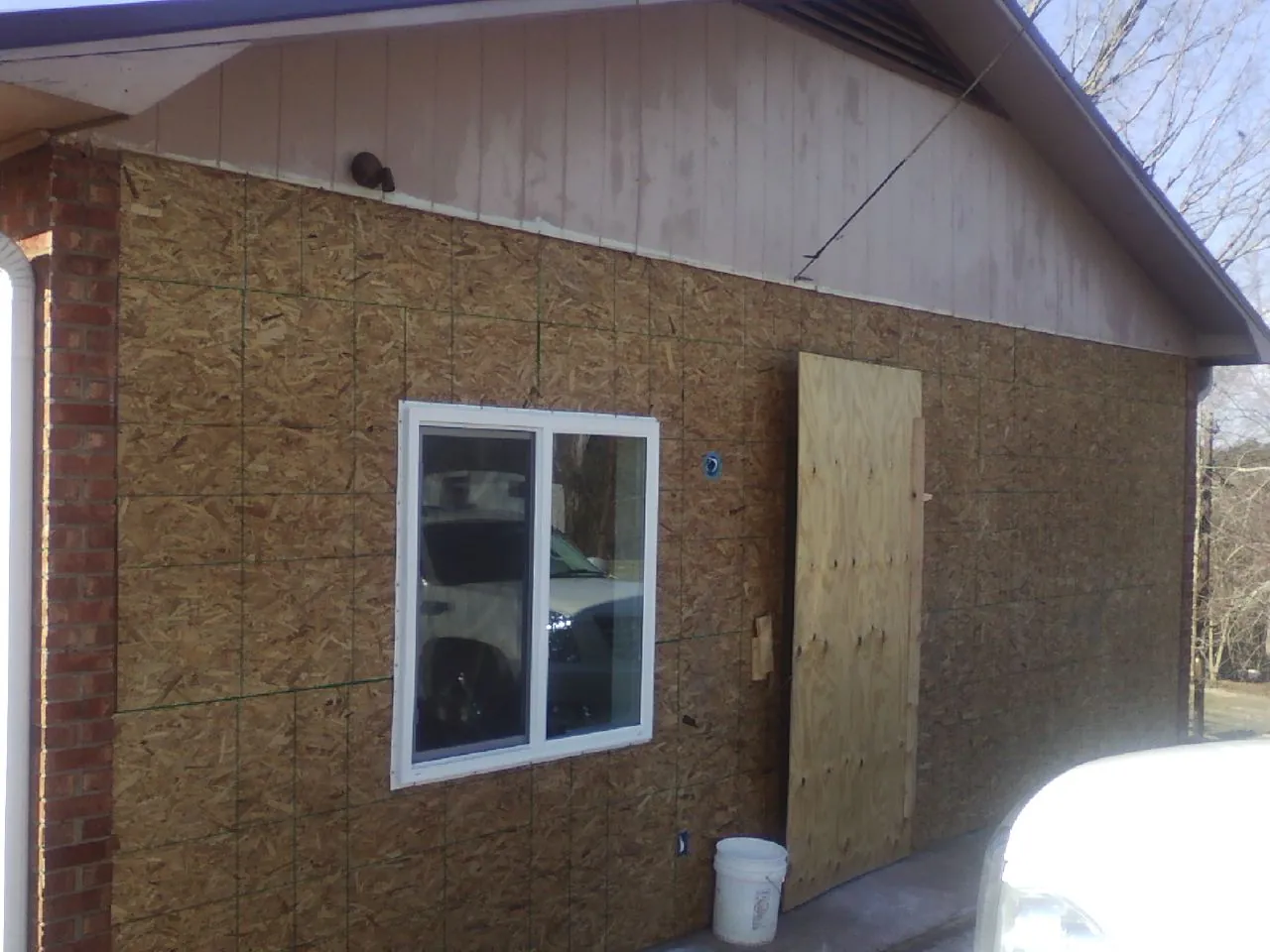 OSB sheathing on a garage addition wall before siding in Hickory Grove